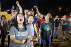 AUGUSTA, NJ USA - AUGUST 5, 2024 -  Friends cheer for their favorite driver. The second night of the Demolition Derby at the NJ State Fair held at the Sussex County Fairgrounds in Augusta.