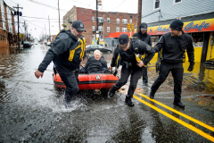 NEWARK, NJ USA - MARCH 23, 2024 -  Members of the Newark Police Emergency Services Unit save Dr. Mark Pollack after his car became flooded while on Pacific St. in Newark’s Ironbound neighborhood. Heavy rain caused mass flooding in the area.