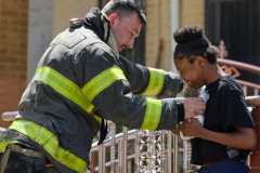 Firefighter Robert Kukulski of Engine Company 257 returns Pickles the kitten to his emotional owner after being found unconscious covered in soot from heavy smoke during a house fire at 612 Chester Street on Thursday, April, 25 2024.  Firefighter Jose Cordero from Engine Company 257 worked for fifth teen minutes to perform cpr and administered oxygen on the cat to regain conscious. The cat was listed in stable condition.
