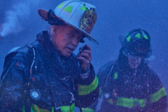 A Battalion Chief listens to radio transmissions while water drips down his helmet during a five alarm fire in the Bushwick neighbourhood of New York City, U.S. May 1, 2024.