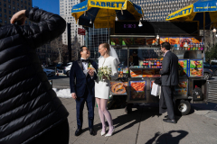 Arthur Siddharta, 31, and Kelly Willinger, 37, share a hot dog to celebrate their marriage after getting married at New York City Marriage Bureau in Manhattan, New York, February 14, 2025.