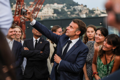 EMMANUEL MACRON takes a selfie with young attendees during the United Nations Ocean Conference in France.
`
