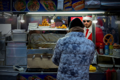 A reveler buys a gyro from a food cart during SantaCon, Saturday, Dec. 14, 2024, in New York.
