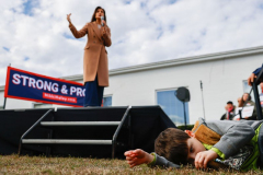 A boy plays with grass as Republican presidential hopeful and former United States Ambassador to the United Nations Nikki Haley speaks at a campaign stop, Monday, February 19, 2024, in Orangeburg, S.C.