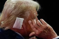 Republican presidential candidate former President Donald Trump points to his ear as he talks to Rep. Jim Jordan, R-Ohio, during the Republican National Convention Tuesday, July 16, 2024, in Milwaukee.