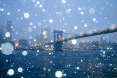 The Brooklyn Bridge is seen as snow falls during a winter storm In the Brooklyn Borough of New York City. Saturday, December 27 2025.