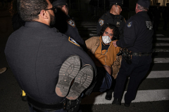 NYPD officers carry away a protester in handcuffs on Oct. 22 after a massive gathering pushed back on the previous day’s ICE raid on Canal Street.