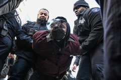A protester is arrested as she fought to prevent a massive ICE operation in Chinatown on Nov. 29.