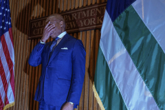 Mayor Eric Adams clutches his face at One Police Plaza as he was peppered with questions by reporters who inquire over a possible resignation.