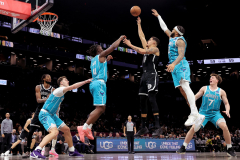 Dec 1, 2025; Brooklyn, New York, USA; Brooklyn Nets forward Michael Porter Jr. (17) takes a shot against Charlotte Hornets center Ryan Kalkbrenner (11) and guard Sion James (4) and forward Miles Bridges (0) and guard Kon Knueppel (7) during the third quarter at Barclays Center.