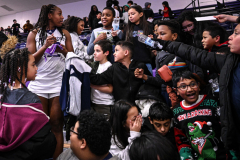 Worcester Public School students reach in for autographs from Holy Cross Crusaders women’s basketball forward Simone Lewis following the conclusion of the team’s annual Field Trip Game against the University of Vermont Catamounts on Tuesday, Dec. 16, 2025 at the Hart Center in Worcester, MA.