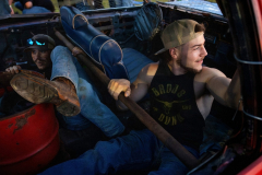 AUGUSTA, NJ USA - AUGUST 3, In the pit area, Paul Kimbel, left, and Logan Benner, of Sussex, NJ, pause to talk to friends and look at a girl as they work on there car to install the gas can behind their seat to protect it during a collison. The New Jersey State Fair’s Demolition Derby is the biggest event at the fair in rural Sussex County. Families pass the spectacle down through generations, and a win earns drivers a year’s worth of bragging rights.