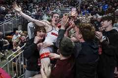 Easton’s Nick Salamone leaps into the stands, where his teammates are, to celebrate beating Cedar Cliff’s Kavin Muyleart at 121 pounds during the PIAA 3A finals on March 8, 2025.