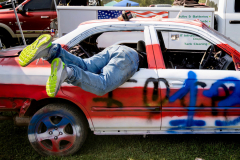 1st Place: Aristide Economopoulos -Independent- Demolition Derby Days - A community comes together over the sounds of metal crunching and engines screaming as they cut through the humid summer night at the New Jersey State Fair as smoke and steam pour from ruptured radiators. The demolition derby, a long-running tradition and the fair’s biggest attraction, pits drivers against one another until only a single car remains running. In this rural community, families pass the spectacle down through generations, and a win earns drivers a year’s worth of bragging rights.

AUGUSTA, NJ USA - AUGUST 3, 2025 - In the pit area, Anthony La Grasta works in moving the fuel tank into the back seat of his 2000 Honda to protect it from collisons before the first night of the 2025 Demolition Derby during the NJ State Fair  held at the Sussex County Fairgrounds.