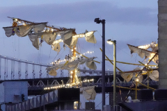 Crew members hang on broken masts after a Mexican Navy training ship, The Cuauhtemoc, hit the bottom of the Brooklyn Bridge in the East River on May 17, 2024 in New York, NY.