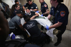 A photographer is rushed to hospital after being thrown to the ground by ICE agents inside 26 Federal Plaza on Sept. 30, 2025.