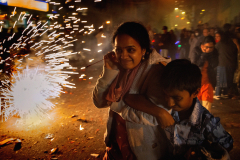 JERSEY CITY, NJ, USA - OCTOBER 20, 2025 - A mother shields her son while walking past fireworks. The Indian community in Jersey City, NJ, one of the biggest in America, celebrates Diwali, the Hindu festival of lights, which symbolises the spiritual victory of light over darkness, good over evil, and knowledge over ignorance.