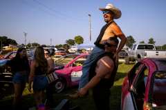 AUGUSTA, NJ USA - AUGUST 3, 2025 - Kyle Conklin jokes around with his friend Dave as he is lifted into the air by him while they hang out with friends in the pit area on first night of the 2025 Demolition Derby during the NJ State Fair  held at the Sussex County Fairgrounds.
