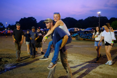 AUGUSTA, NJ USA - AUGUST 4, 2025 - People walk from the pit area to the arena to get a good place to watch the next heat during the second night of the 2025 Demolition Derby during the NJ State Fair held at the Sussex County Fairgrounds.