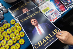 GLENDALE, AZ USA - SEPTEMBER 21, 2025 -  At a Turning Point table, people were able to pick out and take buttons and stickers and a poster of Kirk. The Charlie Kirk Memorial at State Farm Stadium.